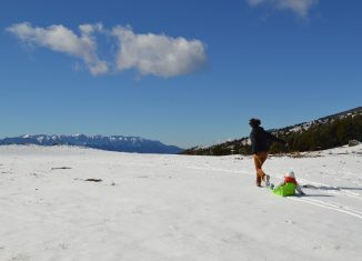 Une femme qui tire un enfant sur une luge à la montagne